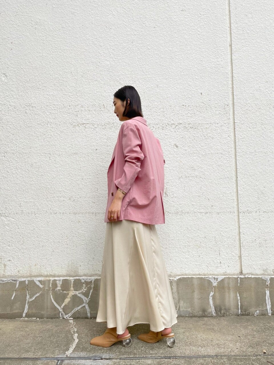 ホワイト系のスカート、ベージュ系のブーツ、ピンク系のテーラードジャケットを着用したレディースの春コーディネートの4枚目の写真