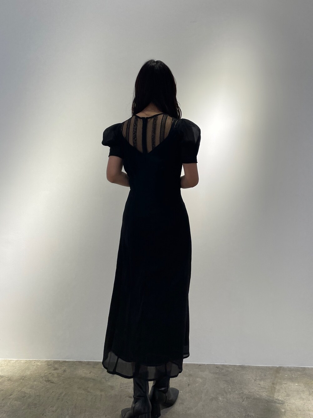 ブラック系のドレス、ブラック系のブーツを着用したレディースの冬コーディネートの4枚目の写真