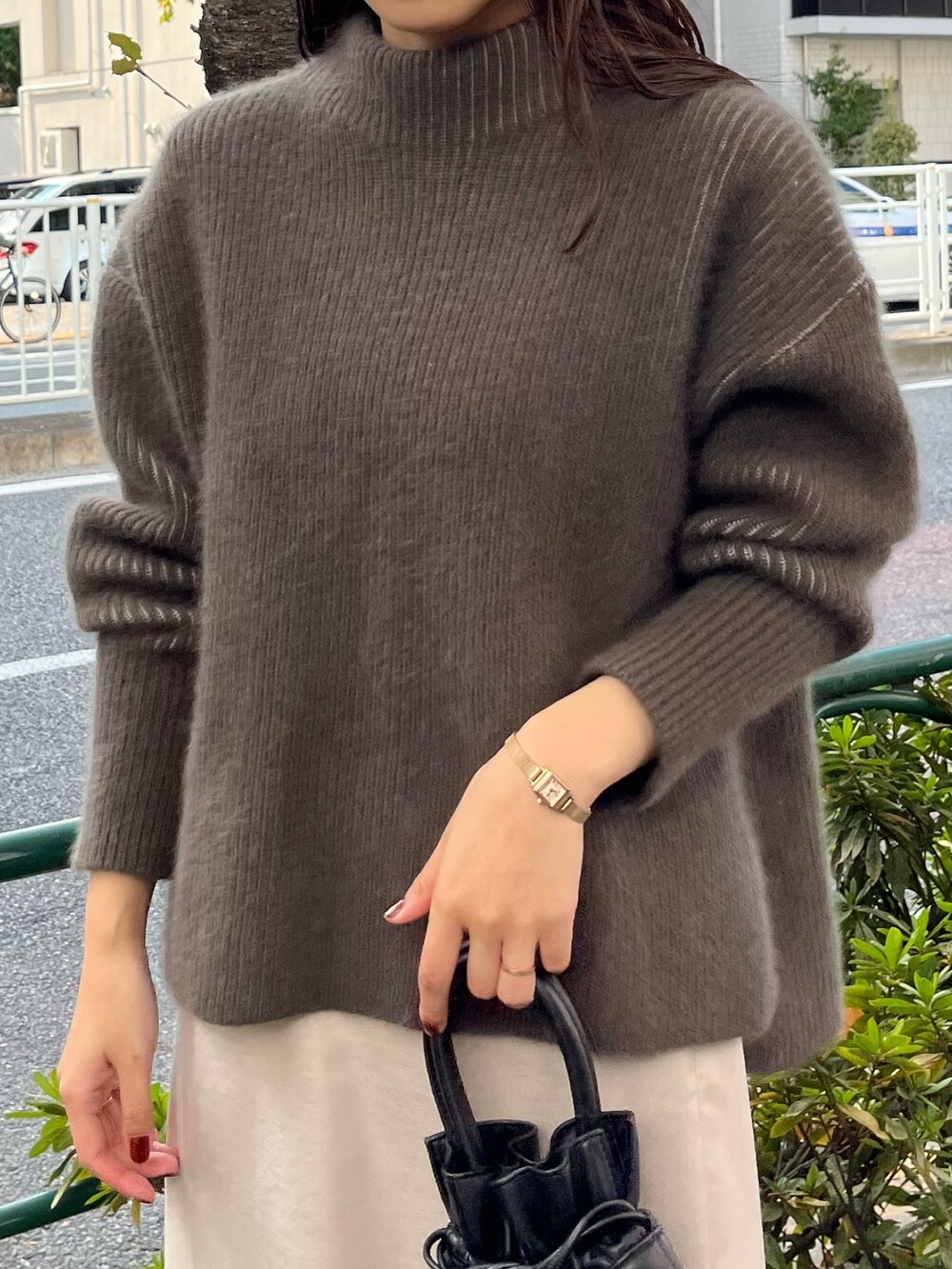 ベージュ系のニット/セーター、ベージュ系のブーツ、グレー系のスカートを着用したレディースの冬コーディネートの7枚目の写真