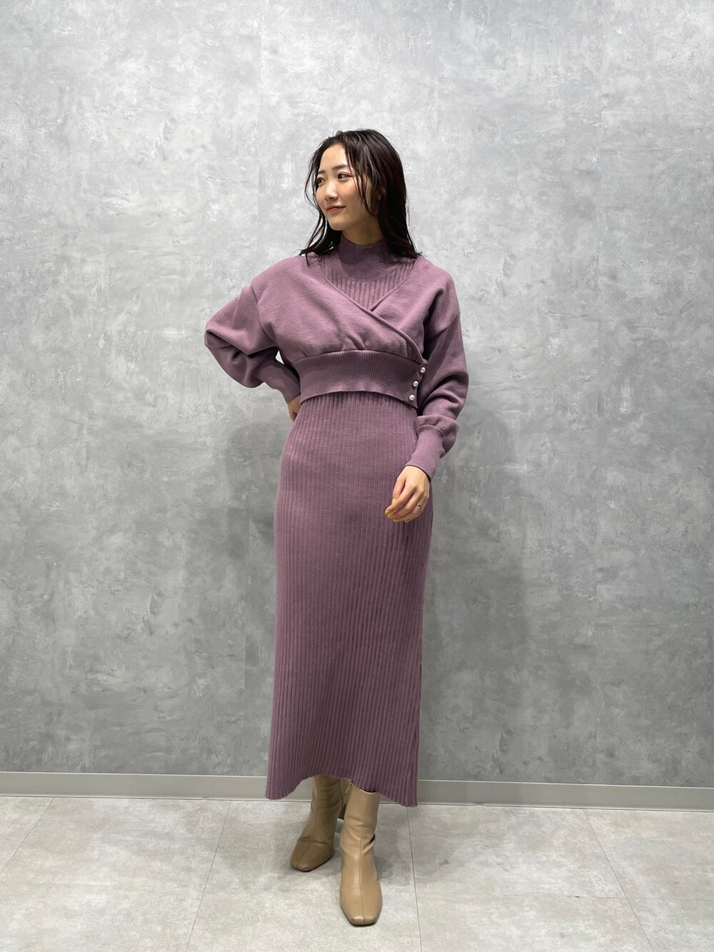 ブラウン系のその他アウター、ベージュ系のブーツ、パープル系のワンピースを着用したレディースの冬コーディネートの8枚目の写真