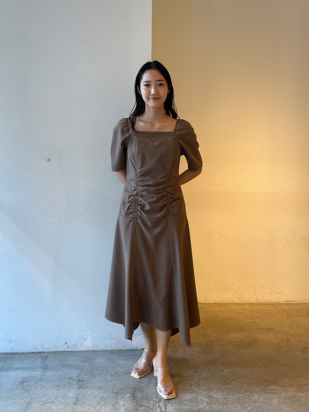 ベージュ系のサンダル、ブラウン系のワンピースを着用したレディースの冬コーディネートの2枚目の写真