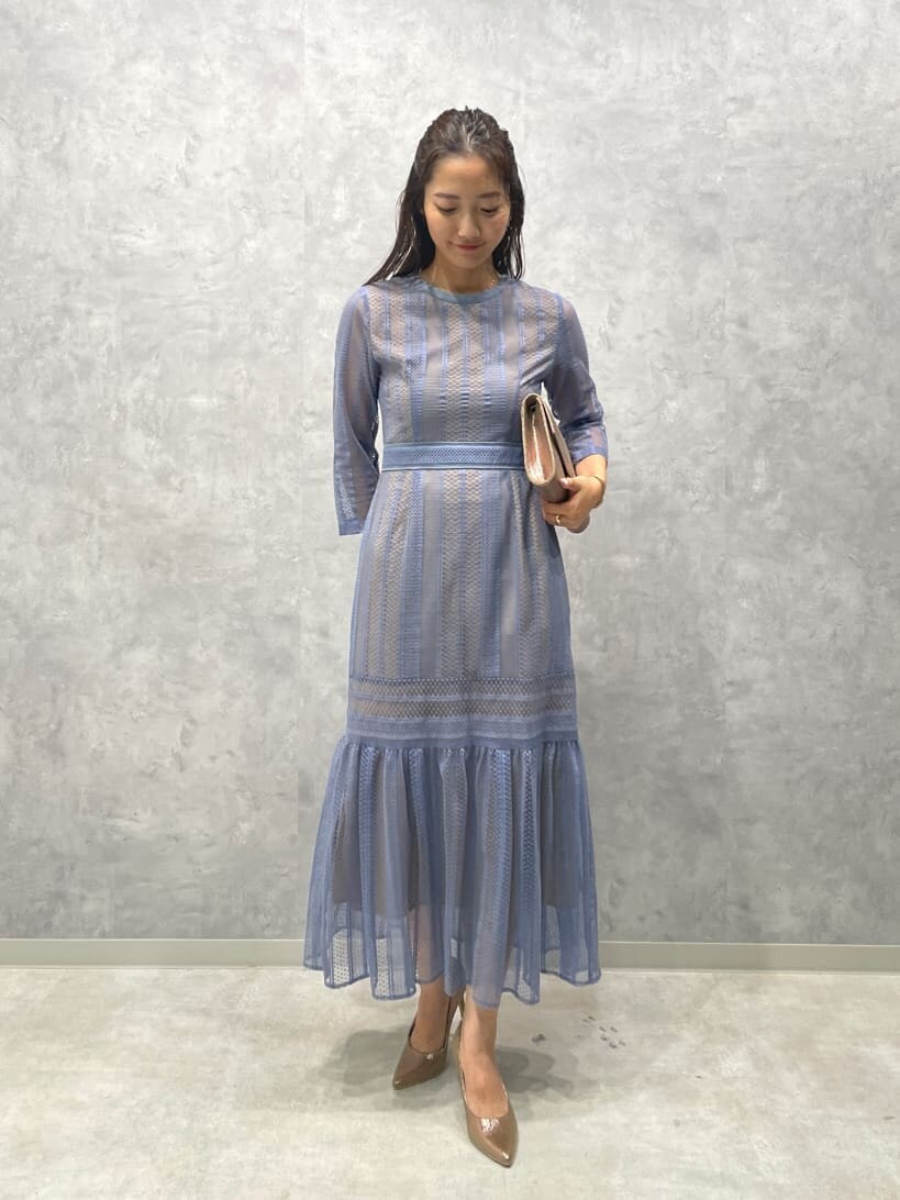 ゴールド系のパンプス、ゴールド系のクラッチバッグ、ブルー系のドレスを着用したレディースの夏コーディネートの2枚目の写真