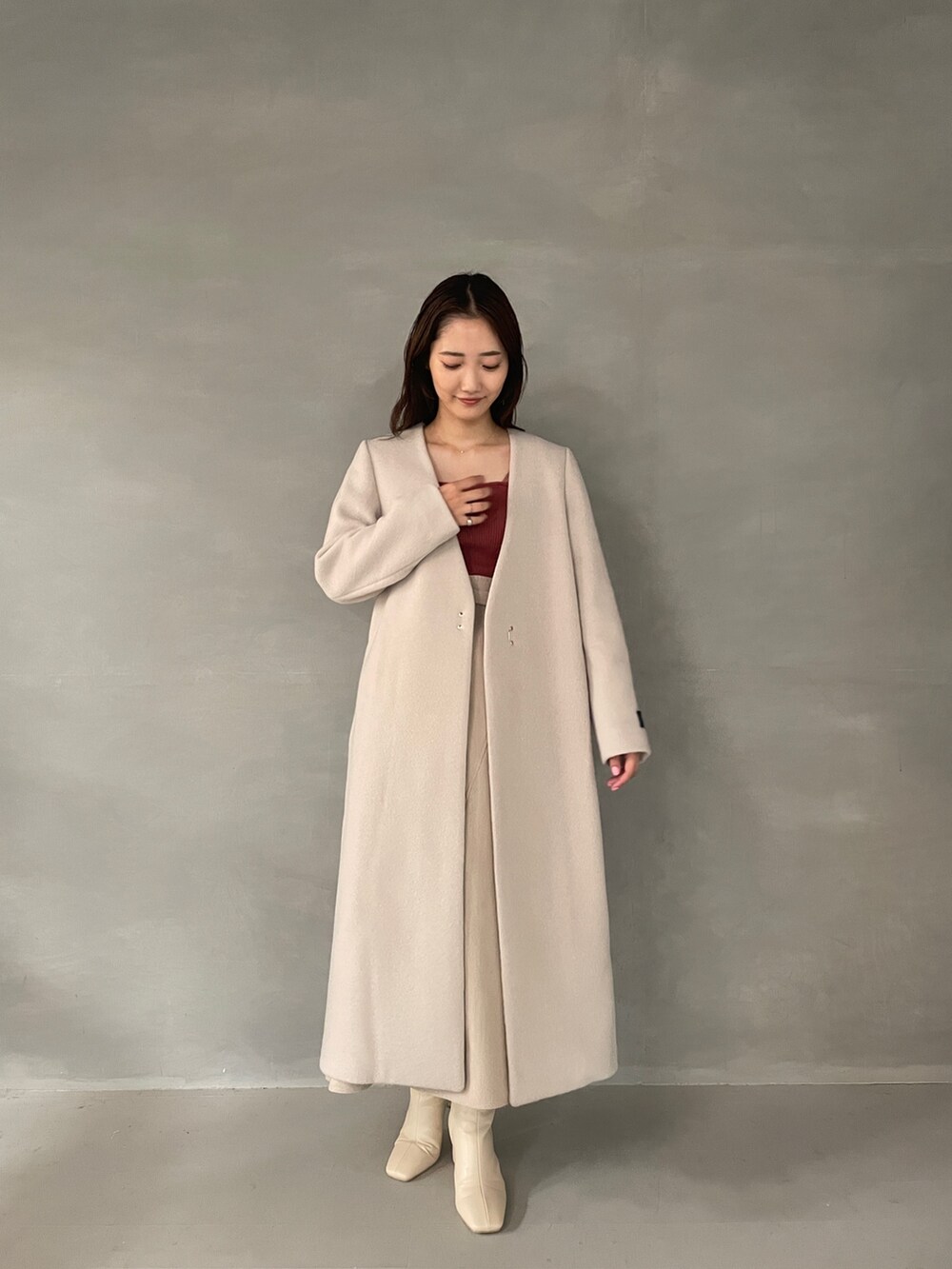 ホワイト系のブーツ、ベージュ系のスカート、ピンク系のニット/セーターを着用したレディースの夏コーディネートの9枚目の写真