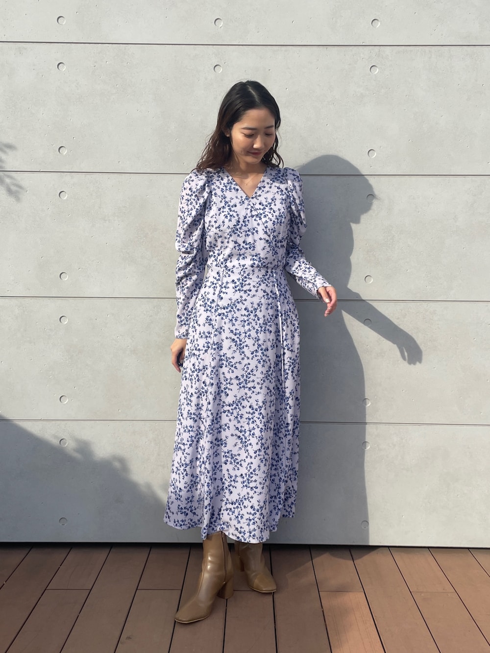 パープル系のワンピース、ベージュ系のブーツを着用したレディースの冬コーディネートの3枚目の写真