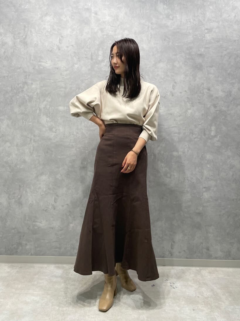 ベージュ系のブーツ、ブラウン系のスカート、イエロー系のカーディガン/ボレロを着用したレディースの秋コーディネートの5枚目の写真