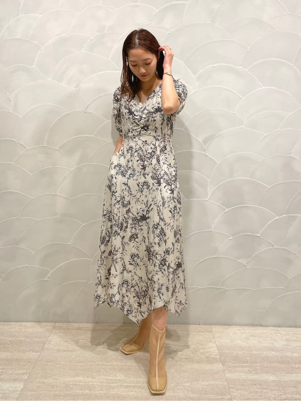 パープル系のテーラードジャケット、ベージュ系のブーツ、グレー系のワンピースを着用したレディースの春コーディネートの4枚目の写真