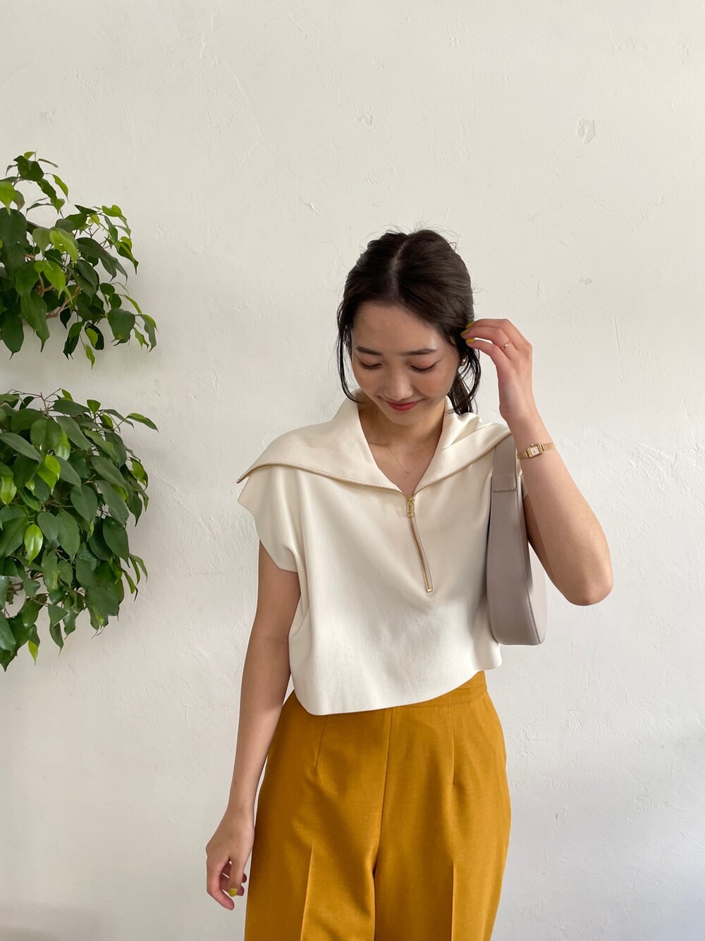 ベージュ系のサンダル、ホワイト系のニット/セーター、イエロー系のスラックスを着用したレディースの春コーディネートの4枚目の写真