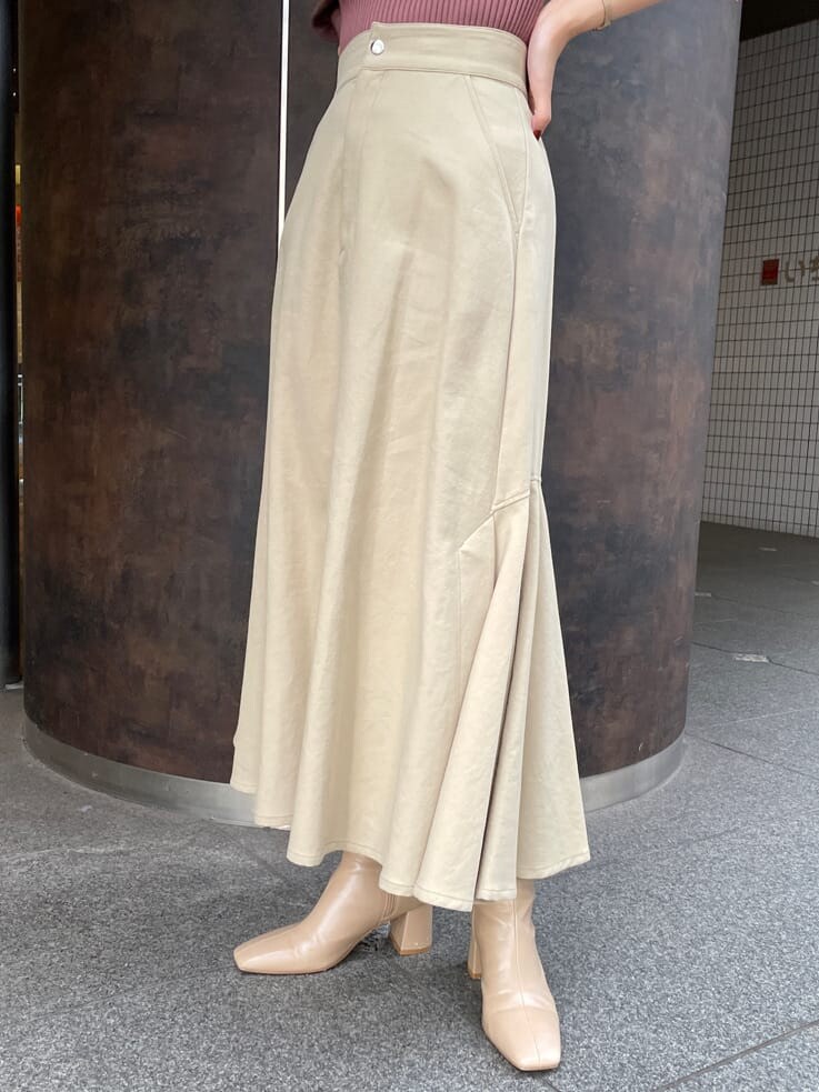 ベージュ系のスカート、ブラウン系のニット/セーター、ベージュ系のスカートを着用したレディースの秋コーディネートの8枚目の写真