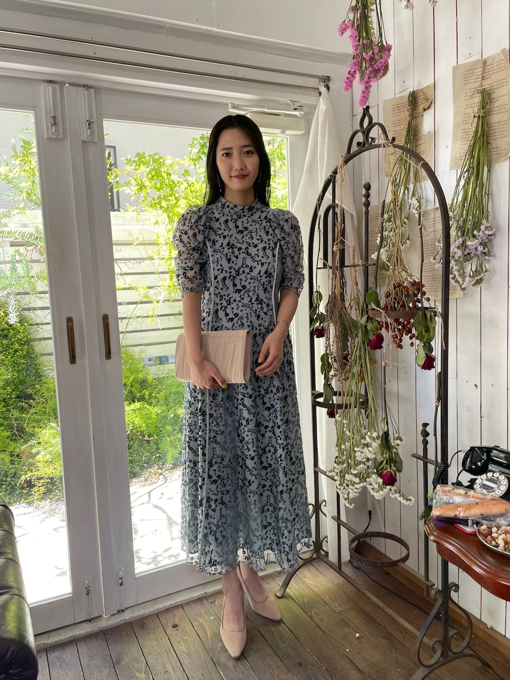 ゴールド系のパンプス、ベージュ系のハンドバッグ、グリーン系のドレスを着用したレディースの夏コーディネートの4枚目の写真