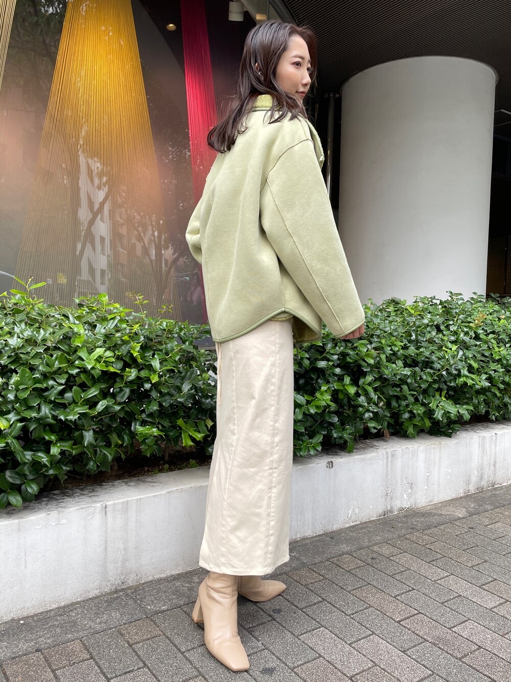 ベージュ系のブーツ、ブラック系のニット/セーター、ホワイト系のスカートを着用したレディースの秋コーディネートの4枚目の写真