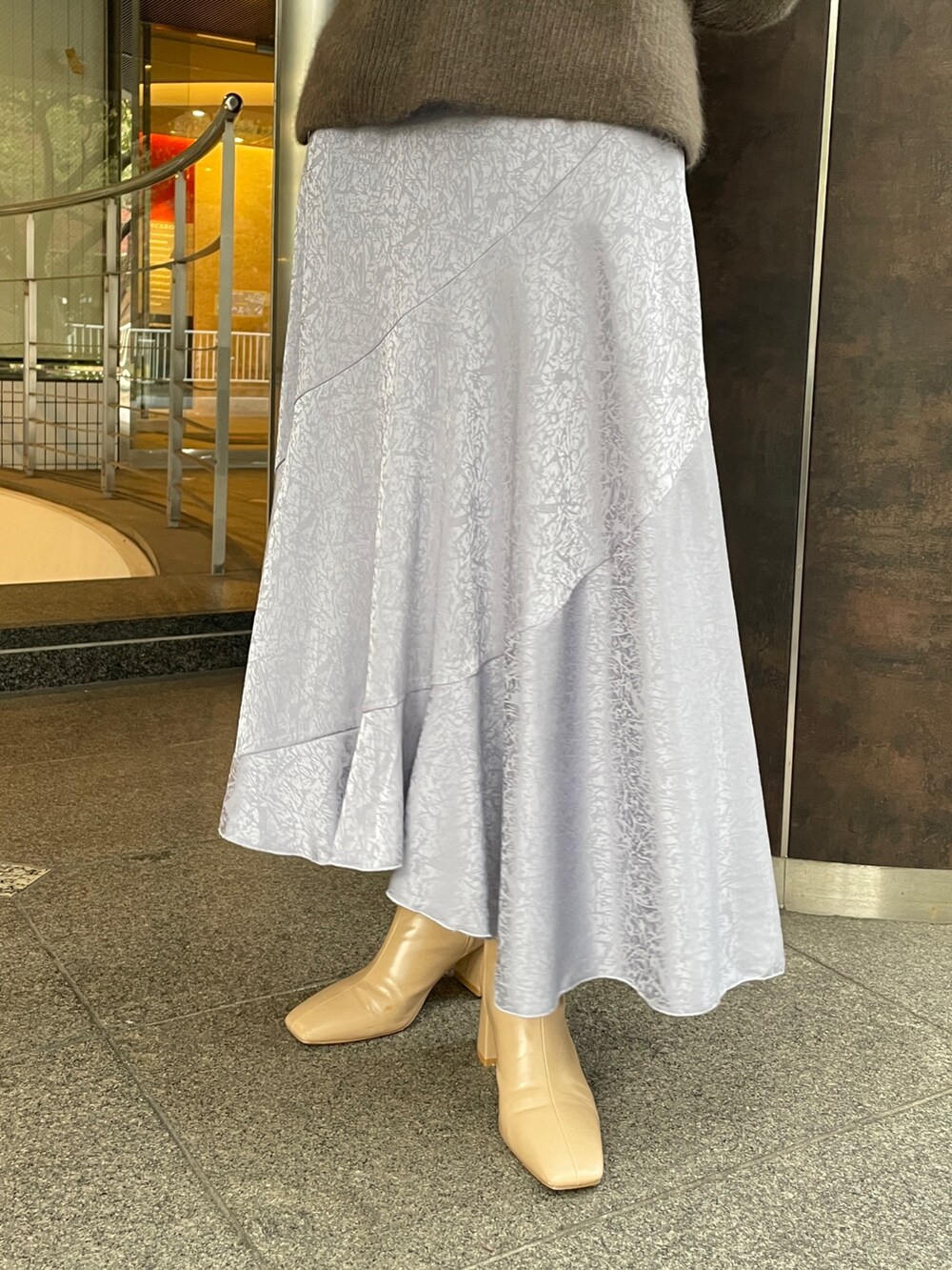 ベージュ系のニット/セーター、ベージュ系のブーツ、ブラック系のその他アウターを着用したレディースの冬コーディネートの9枚目の写真