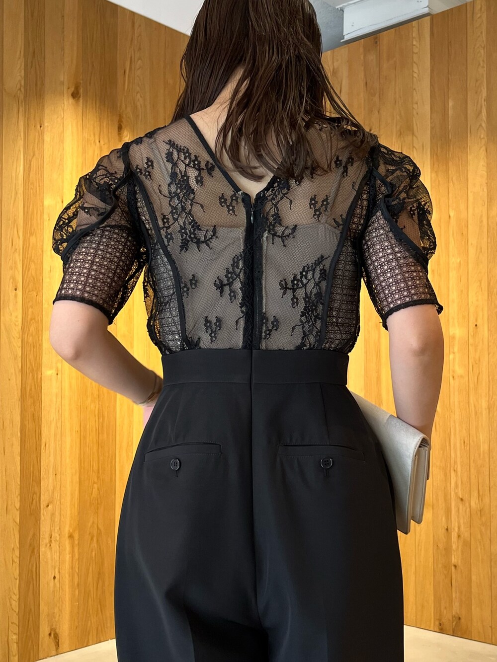 ベージュ系のパンプス、ベージュ系のクラッチバッグ、ブラック系のパンツドレスを着用したレディースの冬コーディネートの8枚目の写真