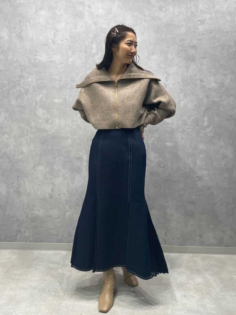 ベージュ系のブーツ、ブルー系のスカート、ベージュ系のカーディガン/ボレロを着用したレディースの秋コーディネートの3枚目の写真