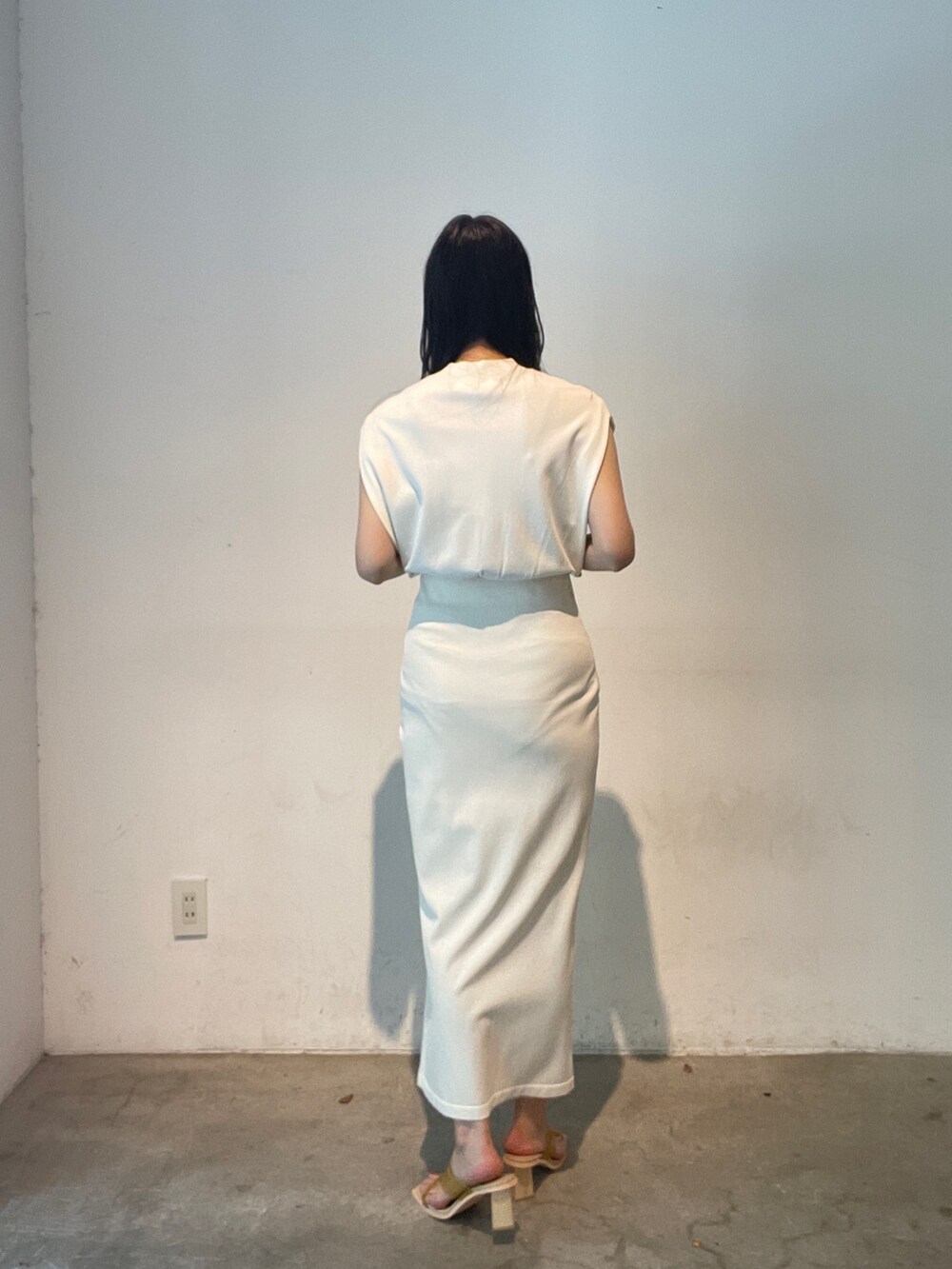 ホワイト系のスカート、ホワイト系のニット/セーター、イエロー系のサンダルを着用したレディースの夏コーディネートの6枚目の写真