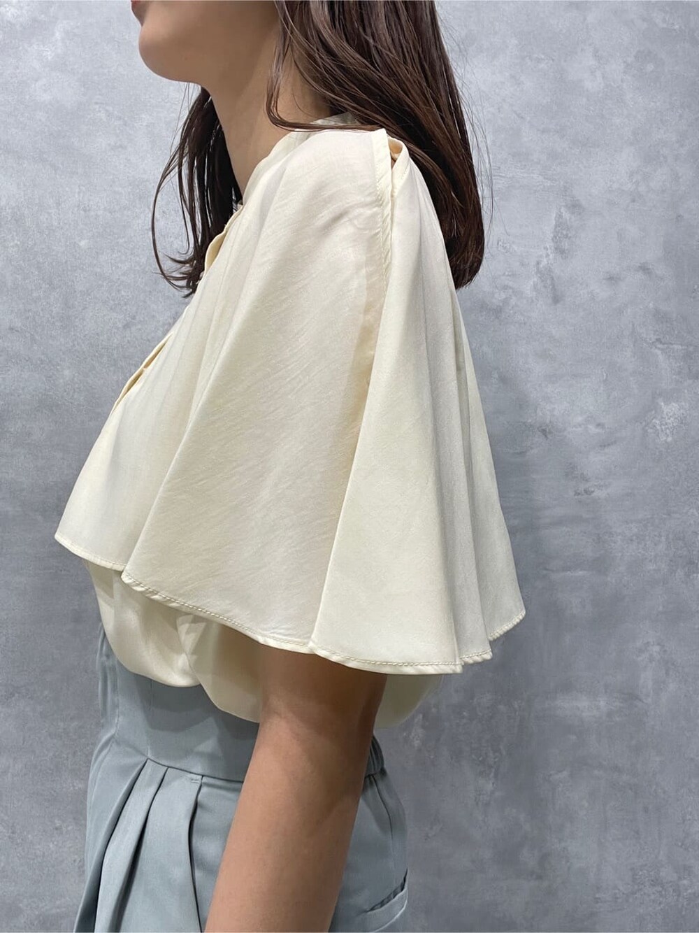 ブルー系のスラックス、ベージュ系のサンダル、ホワイト系のシャツ/ブラウスを着用したレディースの夏コーディネートの6枚目の写真