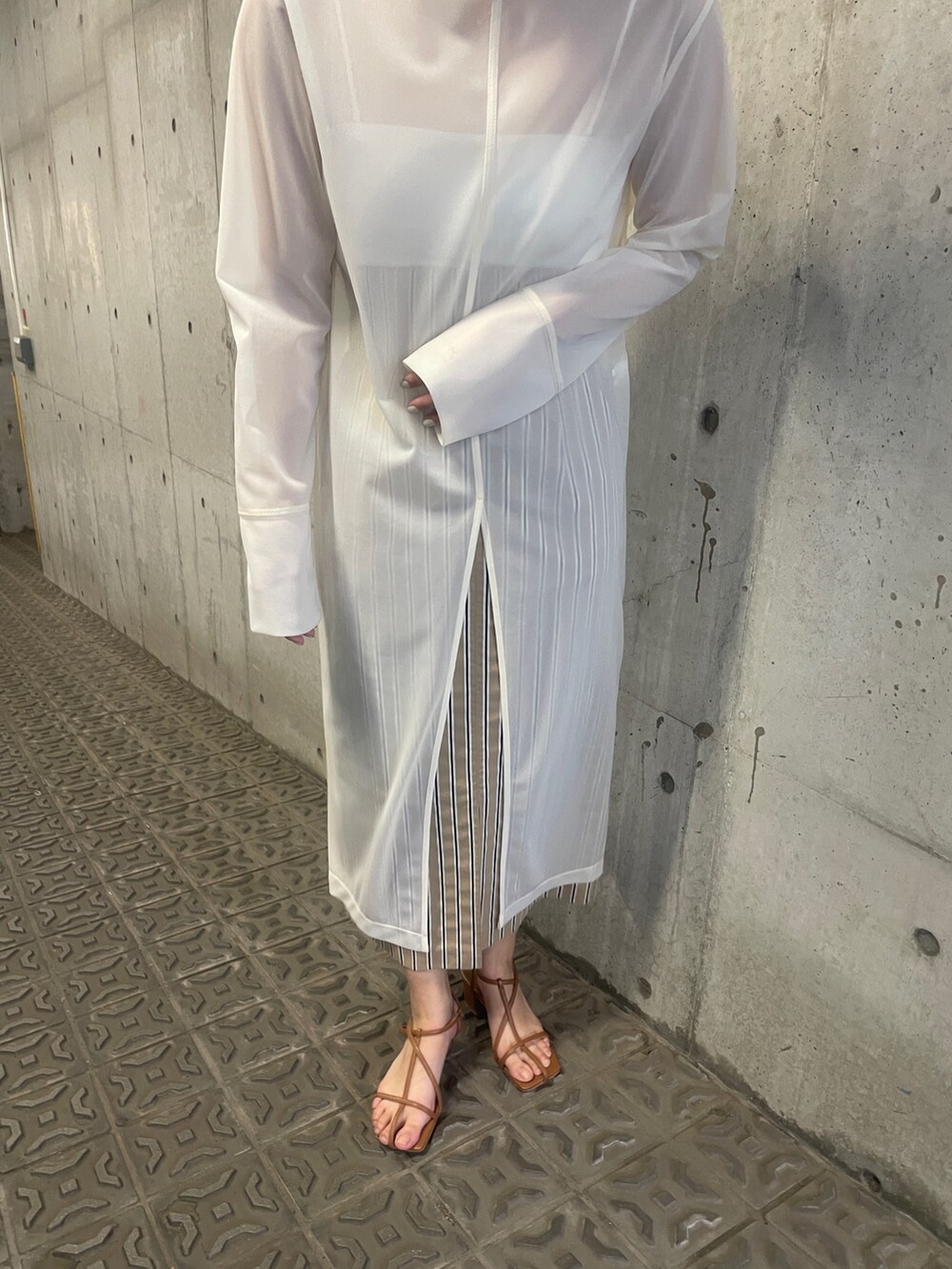 ホワイト系のTシャツ/カットソー、ベージュ系のスカート、ブラウン系のサンダルを着用したレディースの春コーディネートの9枚目の写真