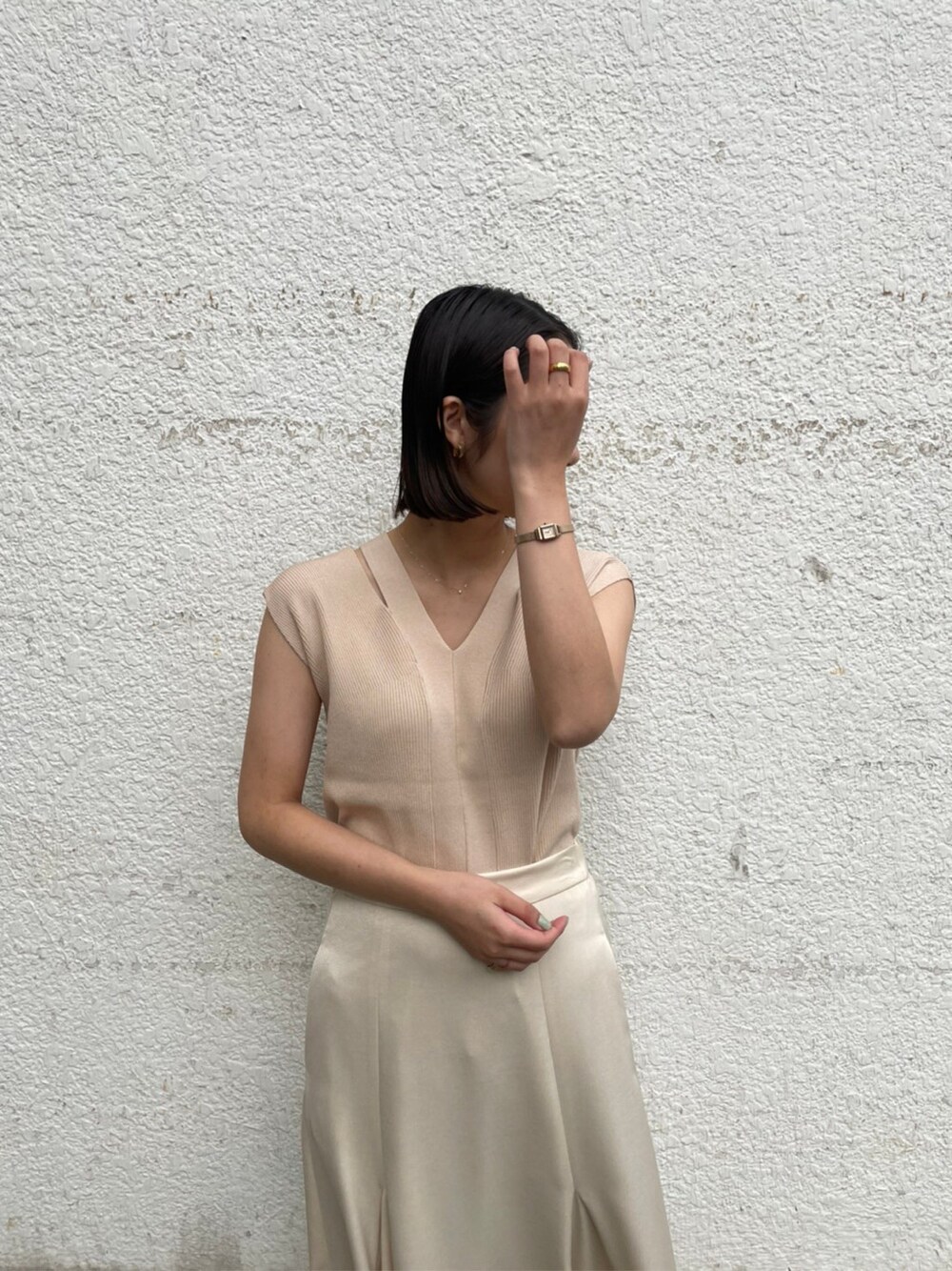 ホワイト系のスカート、ベージュ系のブーツ、ピンク系のテーラードジャケットを着用したレディースの春コーディネートの2枚目の写真