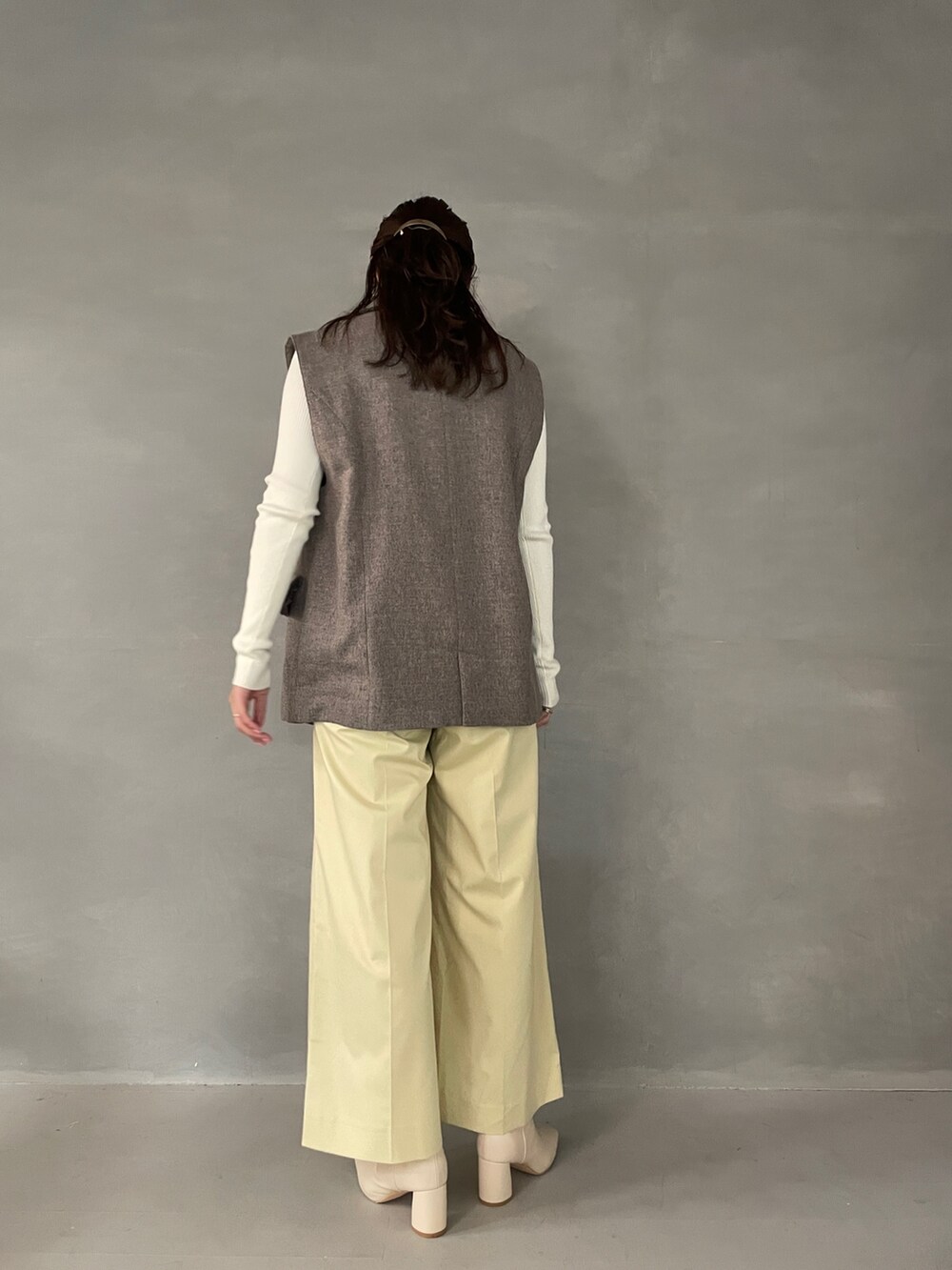 イエロー系のその他パンツ、ホワイト系のブーツ、グレー系のベストを着用したレディースの夏コーディネートの5枚目の写真