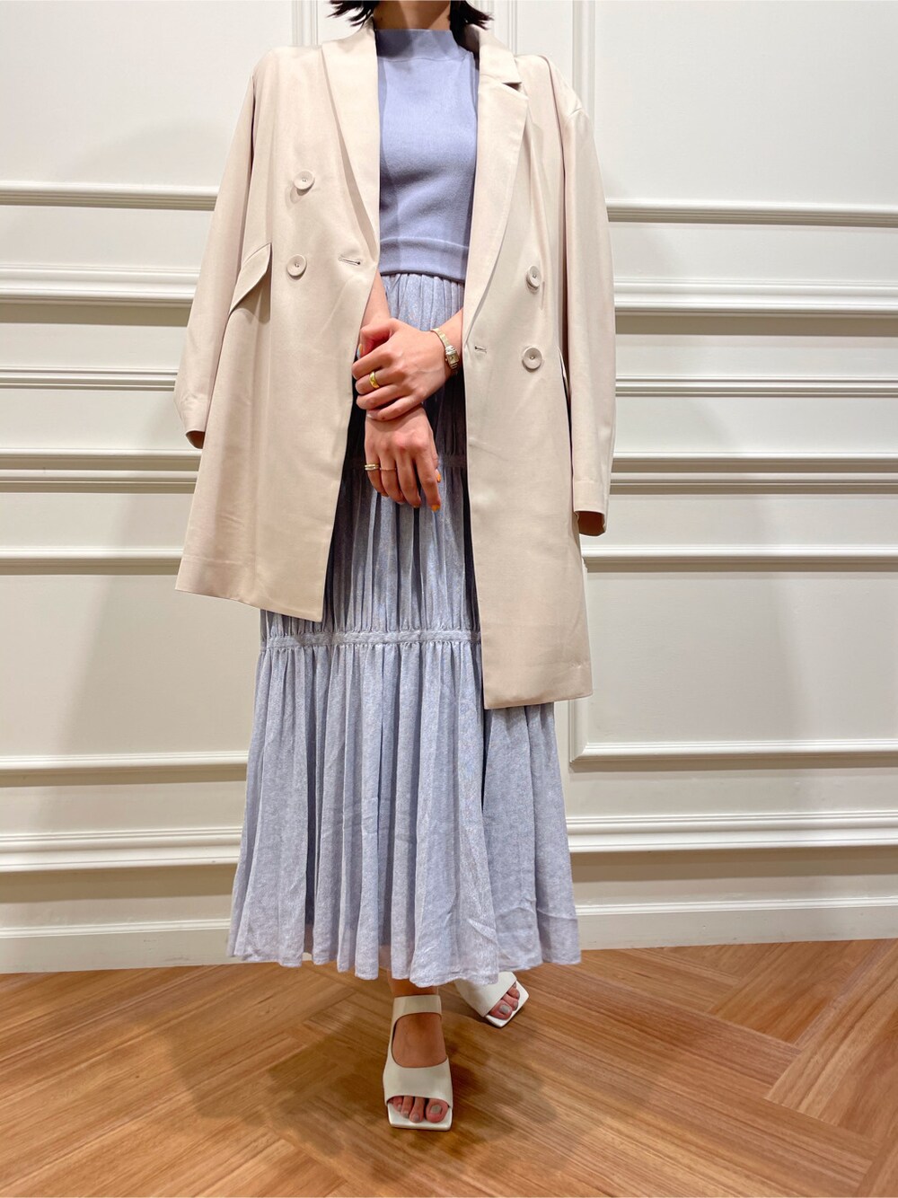 ホワイト系のサンダル、ベージュ系のテーラードジャケット、ブルー系のワンピースを着用したレディースの春コーディネートの5枚目の写真