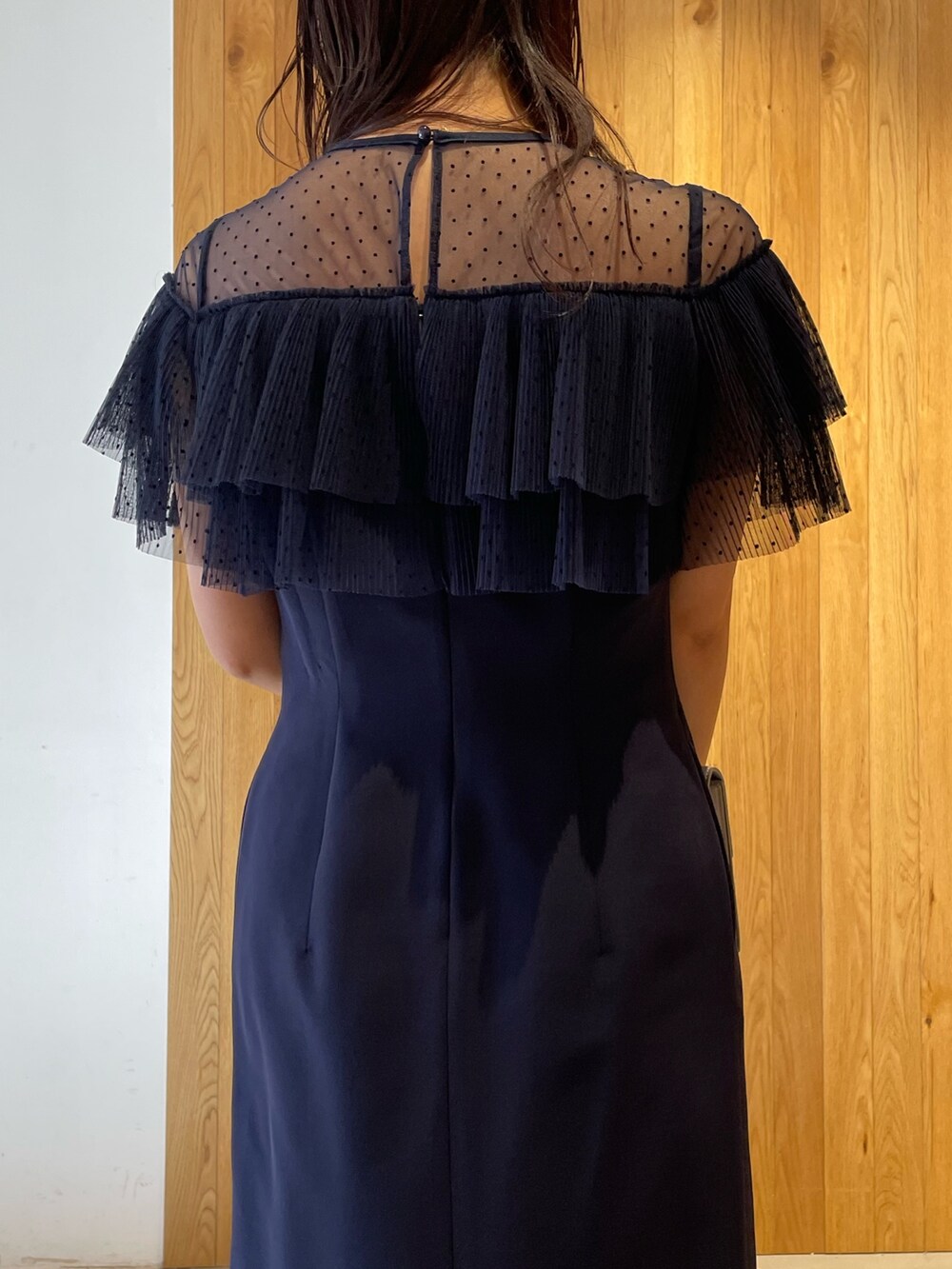 グレー系のパンプス、グレー系のクラッチバッグ、ブルー系のドレスを着用したレディースの冬コーディネートの9枚目の写真