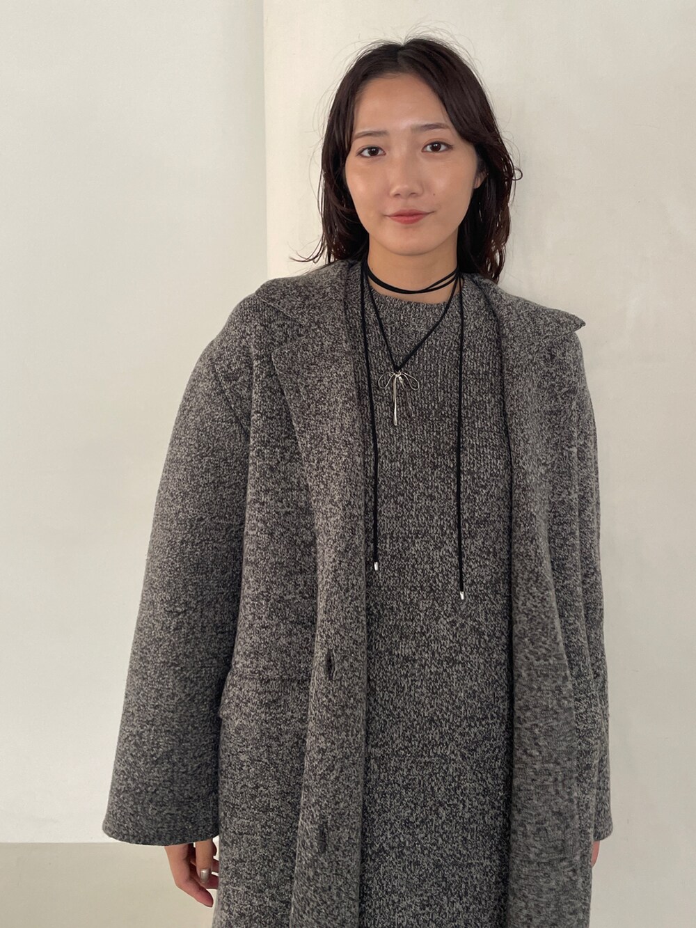 グレー系のワンピース、ブラック系のローファー、グレー系のテーラードジャケットを着用したレディースの冬コーディネートの6枚目の写真