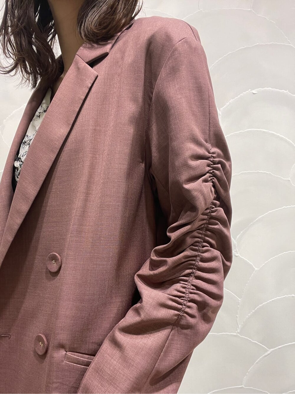 パープル系のテーラードジャケット、ベージュ系のブーツ、グレー系のワンピースを着用したレディースの春コーディネートの8枚目の写真