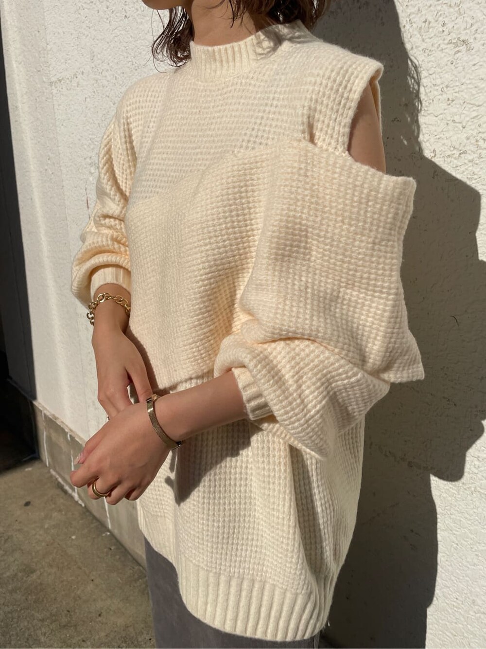 グレー系のスカート、ホワイト系のニット/セーターを着用したレディースの冬コーディネートの4枚目の写真