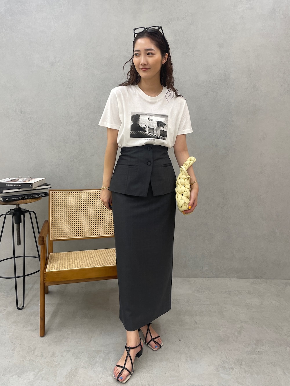 ベージュ系のハンドバッグ、ブラック系のサンダル、ホワイト系のTシャツ/カットソーを着用したレディースの春コーディネートの4枚目の写真