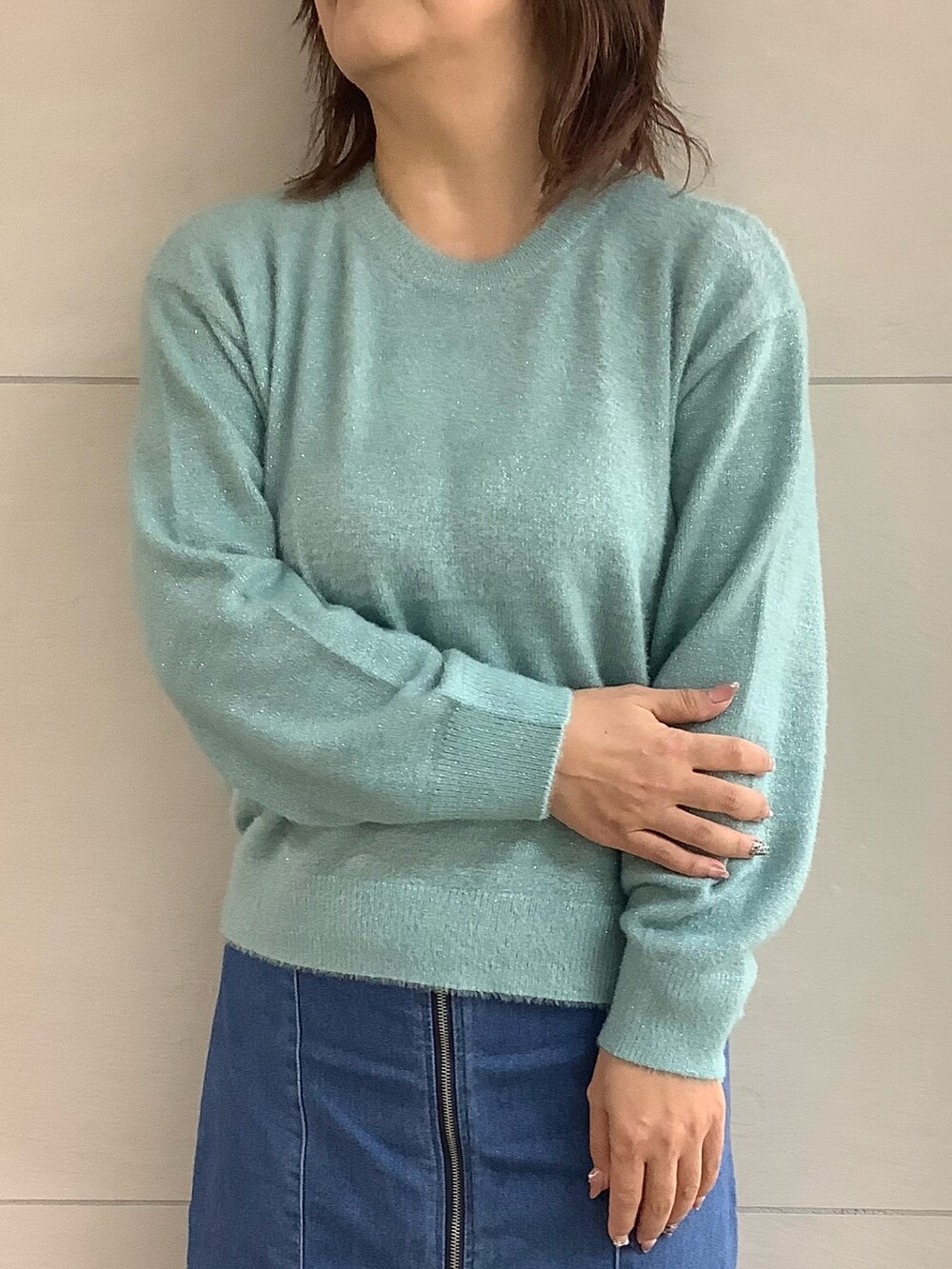 ブルー系のニット/セーターを着用したレディースの冬コーディネートの2枚目の写真