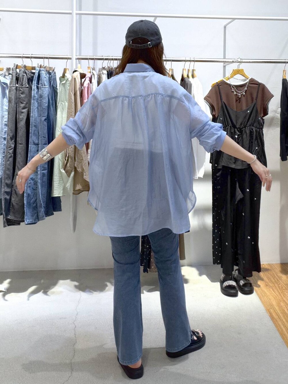 ブルー系のシャツ/ブラウス、ブラック系のサンダル、ブルー系のデニムパンツを着用したレディースの夏コーディネートの7枚目の写真