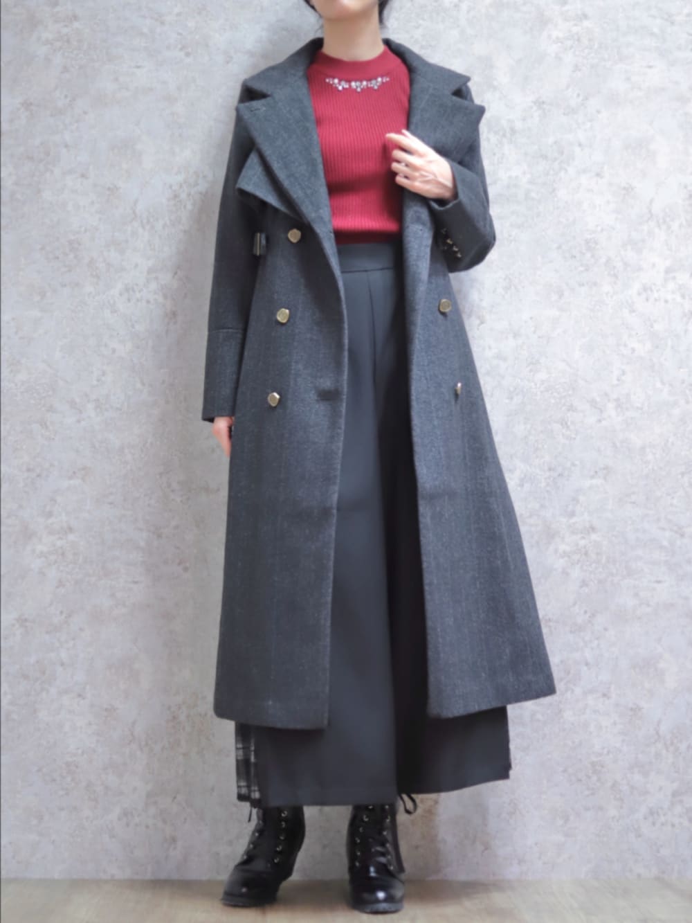 レッド系のニット/セーター、グレー系のダッフルコート、ブラック系のその他パンツを着用したレディースの秋コーディネートの2枚目の写真