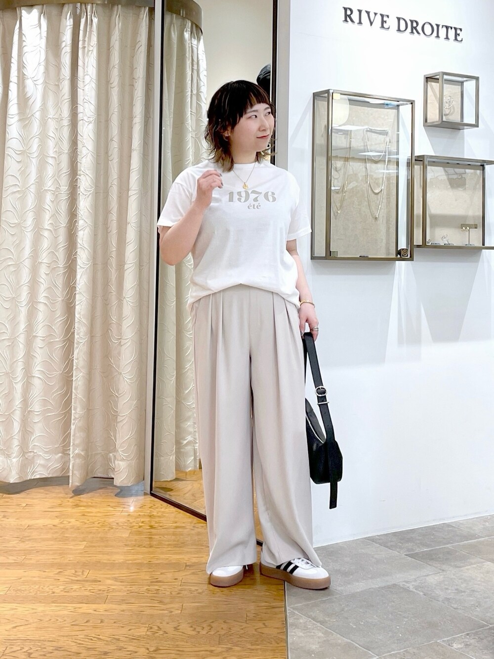 グレー系のスラックス、グレー系のシャツ/ブラウス、ホワイト系のTシャツ/カットソーを着用したレディースの春コーディネートの5枚目の写真