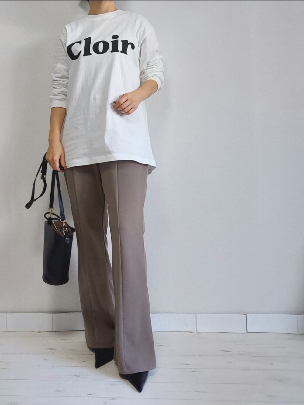 ブラック系のその他アウター、ブラウン系のその他パンツ、ホワイト系のTシャツ/カットソーを着用したレディースの冬コーディネートの2枚目の写真