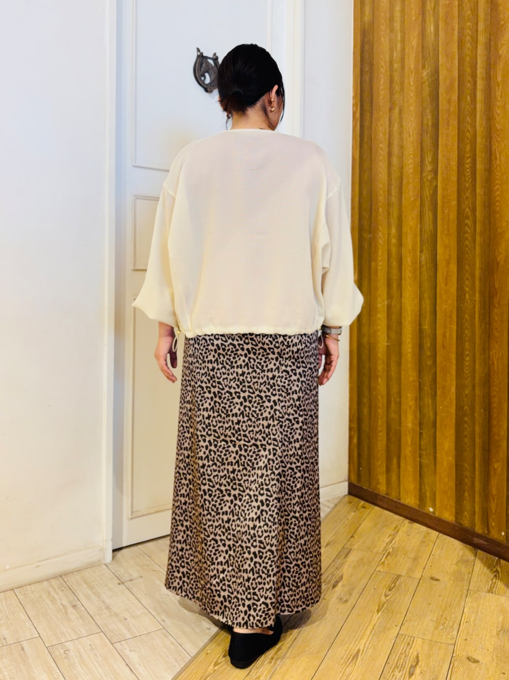 ホワイト系のブルゾン、レッド系のニット/セーター、ブラウン系のスカートを着用したレディースの夏コーディネートの3枚目の写真