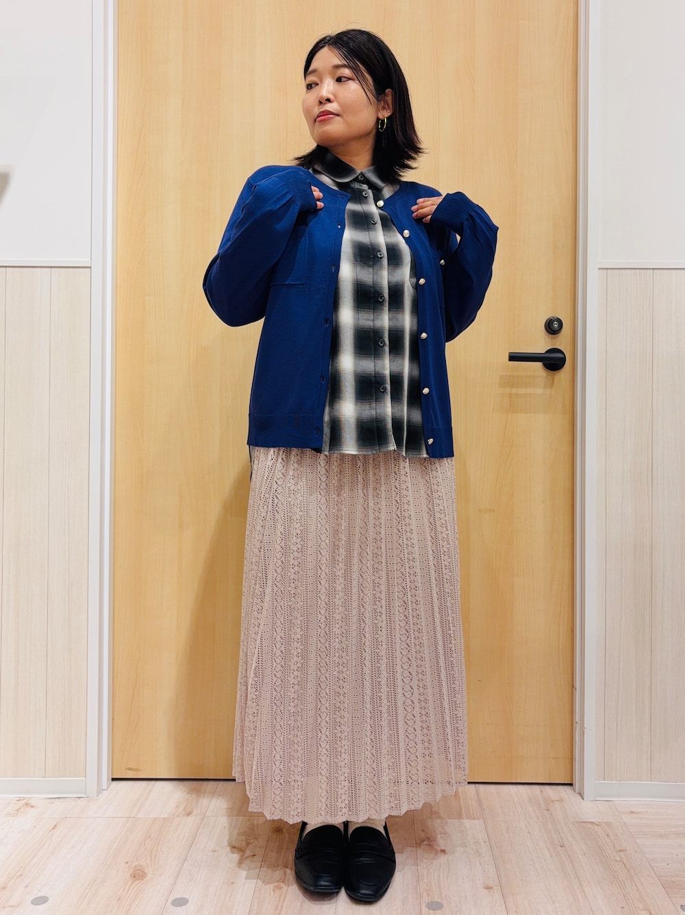 グレー系のシャツ/ブラウス、ブルー系のカーディガン/ボレロ、ベージュ系のスカートを着用したレディースの秋コーディネートの5枚目の写真