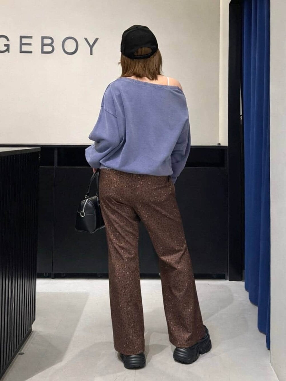 ブラック系のブーツ、ブラック系のボストンバッグ、その他のその他パンツを着用したレディースの冬コーディネートの5枚目の写真