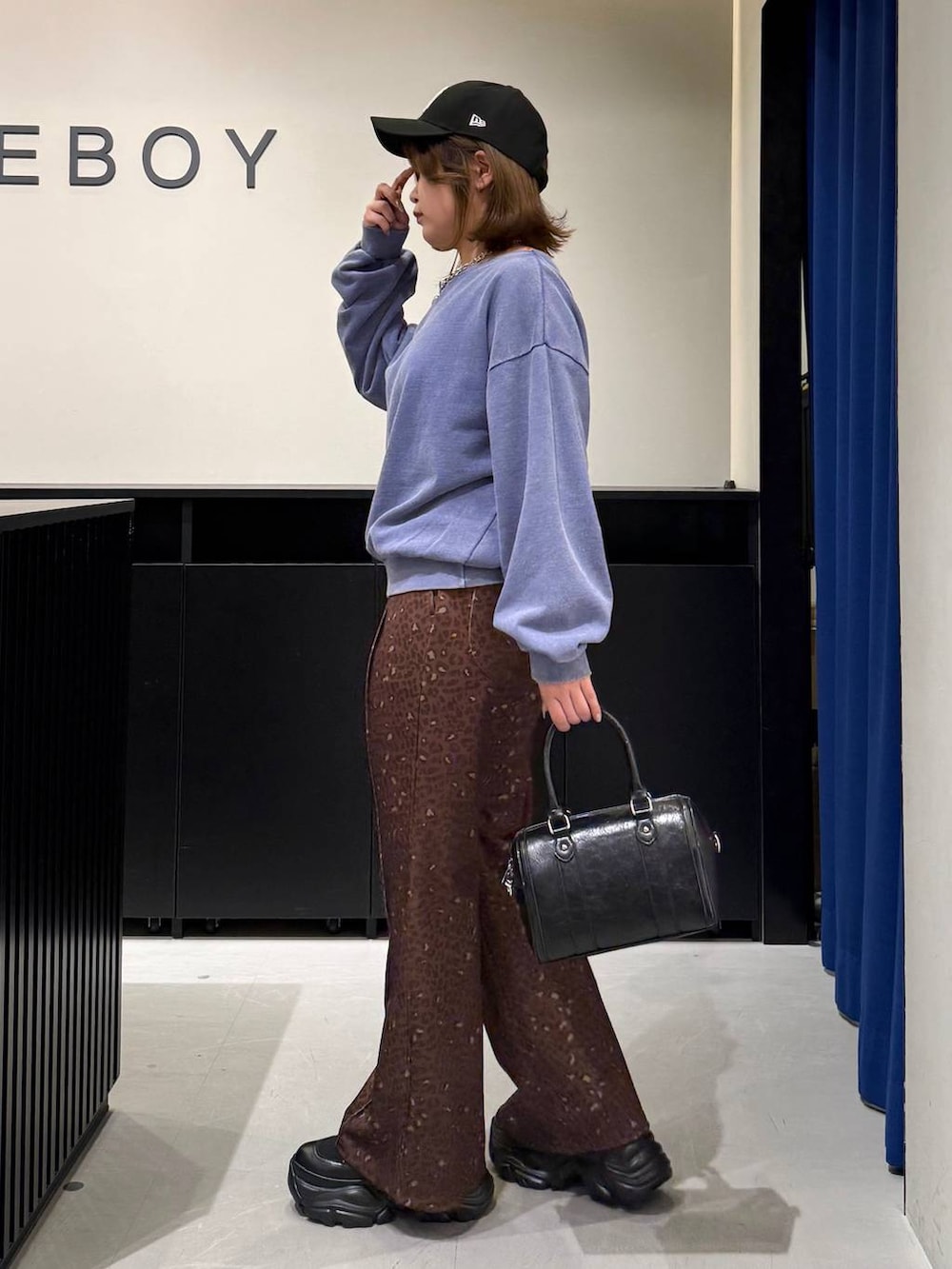 ブラック系のブーツ、ブラック系のボストンバッグ、その他のその他パンツを着用したレディースの冬コーディネートの6枚目の写真