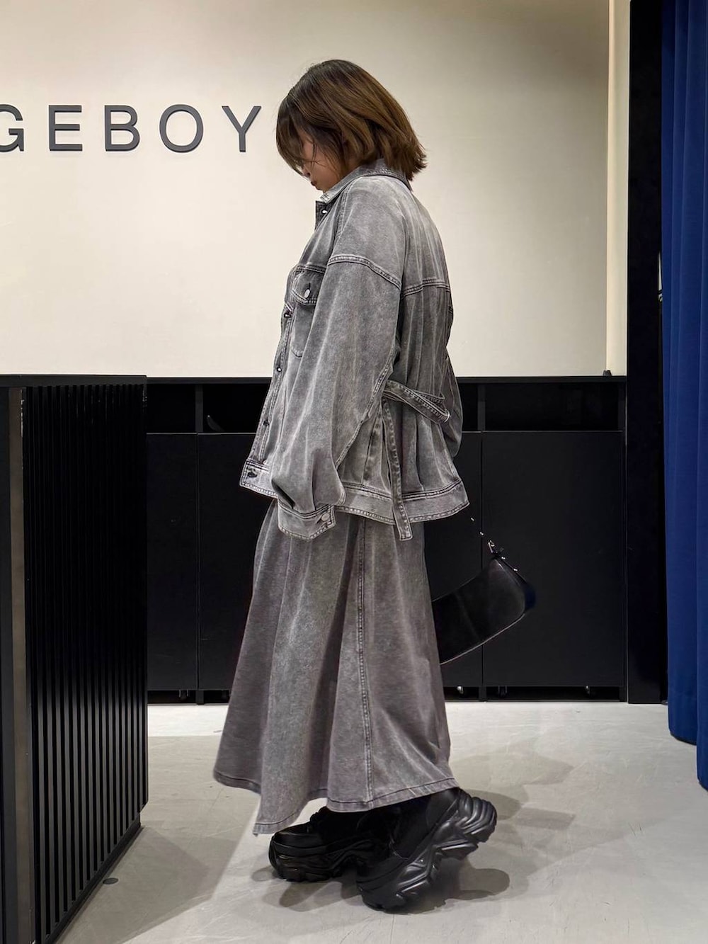 ブラック系のブーツ、ブラック系のハンドバッグ、ブラック系のブルゾンを着用したレディースの冬コーディネートの7枚目の写真