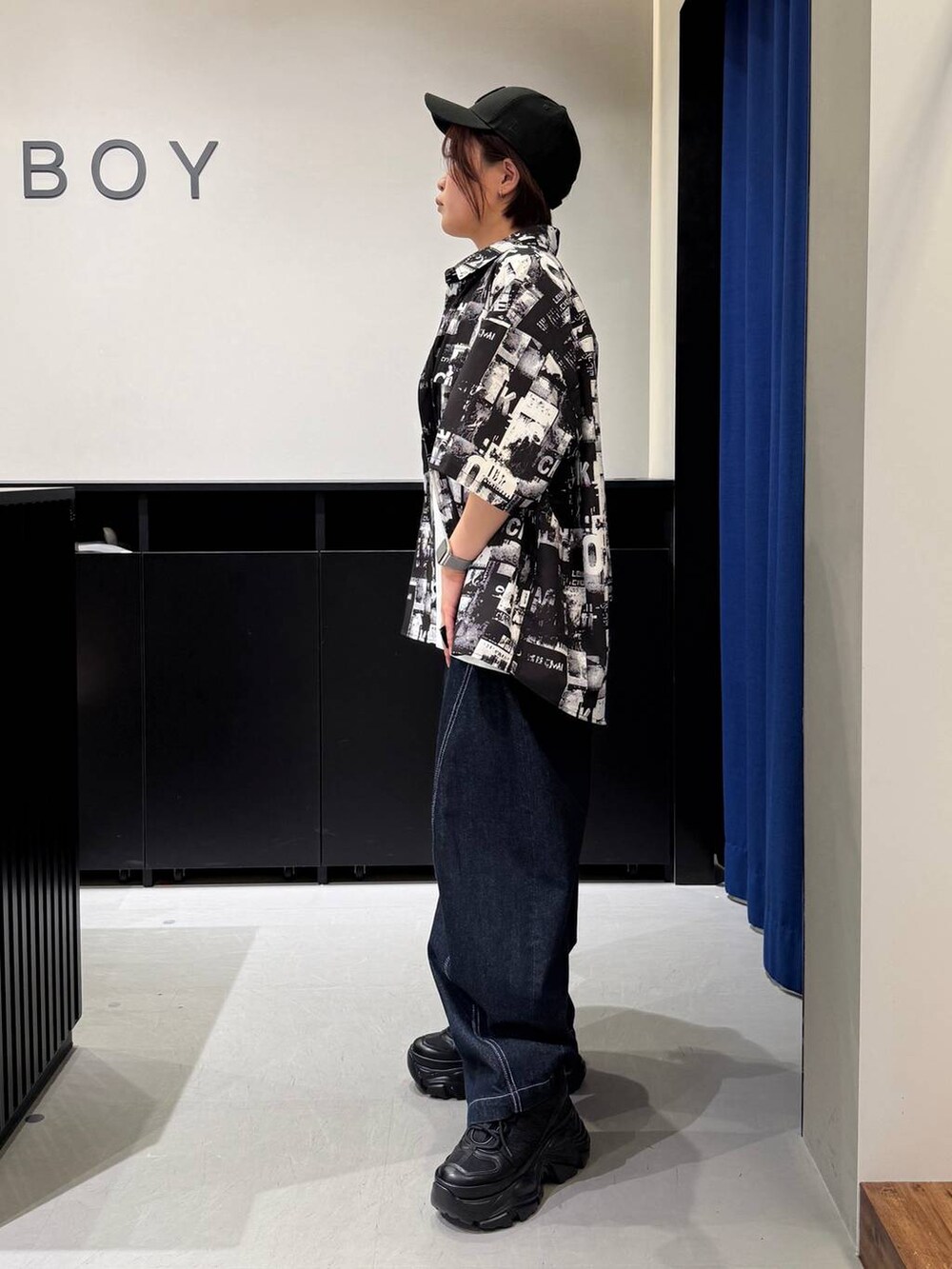 ブラック系のスニーカー、ホワイト系のTシャツ/カットソー、ブラック系のシャツ/ブラウスを着用したレディースの夏コーディネートの6枚目の写真