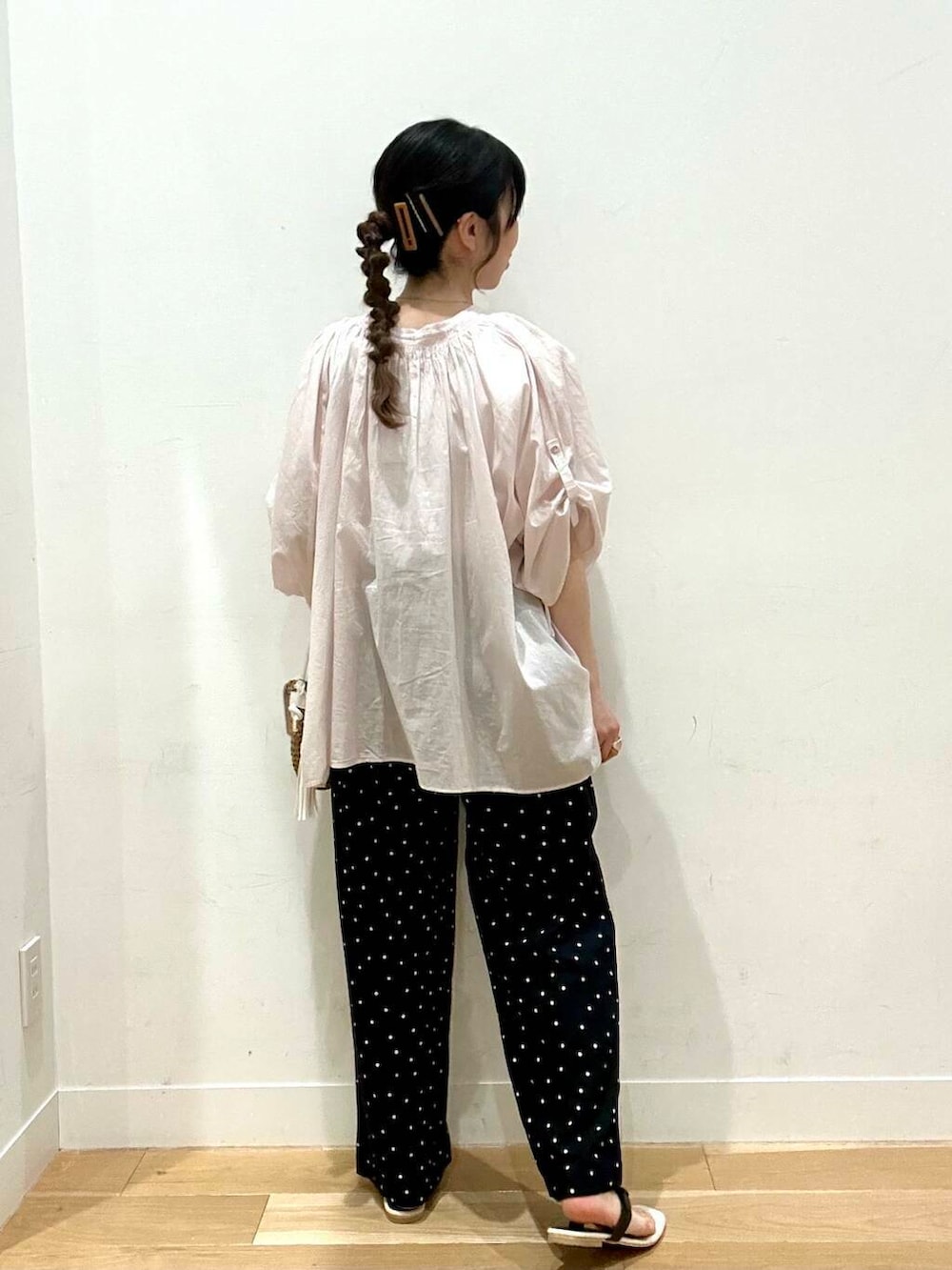 イエロー系のショルダーバッグ、ホワイト系のタンクトップ、ブラック系のその他パンツを着用したレディースの夏コーディネートの2枚目の写真