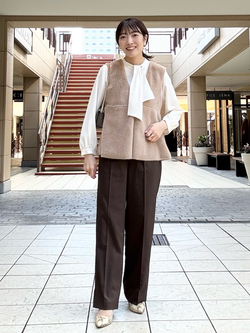 ブラウン系のその他パンツ、イエロー系のブルゾン、ホワイト系のシャツ/ブラウスを着用したレディースの秋コーディネートの5枚目の写真