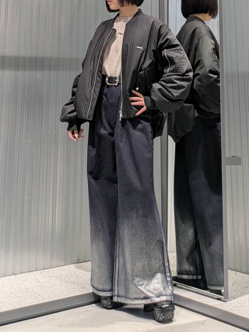 グレー系のブーツ、ブルー系のデニムパンツ、ベージュ系のスウェットを着用したレディースの秋コーディネートの5枚目の写真