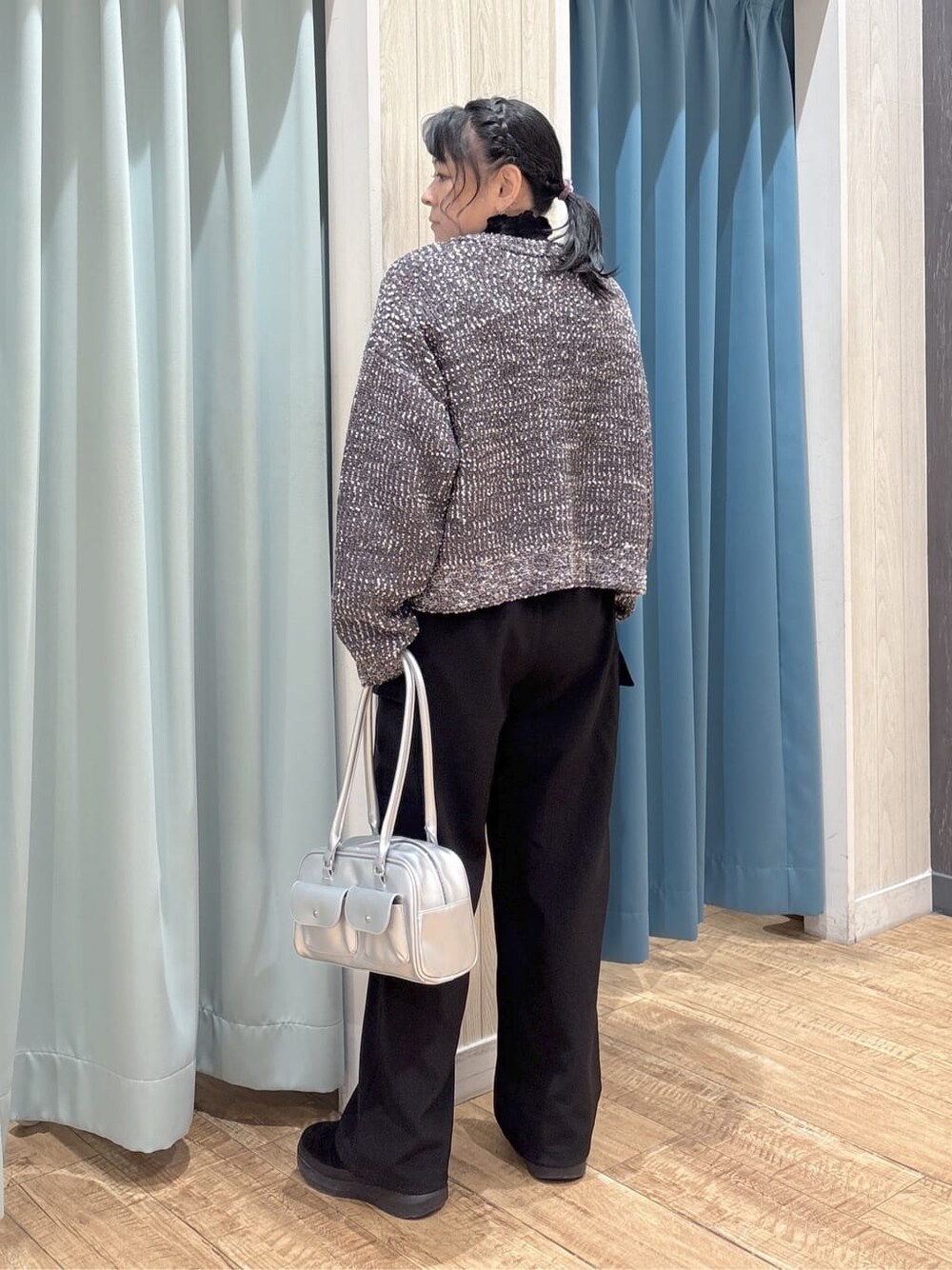シルバー系のボストンバッグ、ブラック系のその他パンツ、グレー系のカーディガン/ボレロを着用したレディースの冬コーディネートの3枚目の写真