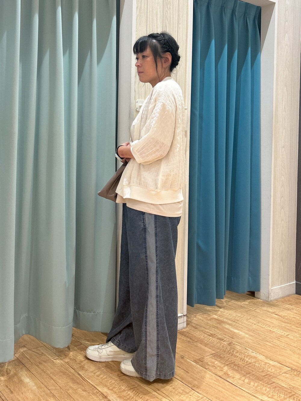 ベージュ系のTシャツ/カットソー、ホワイト系のカーディガン/ボレロ、グレー系のトートバッグを着用したレディースの夏コーディネートの2枚目の写真