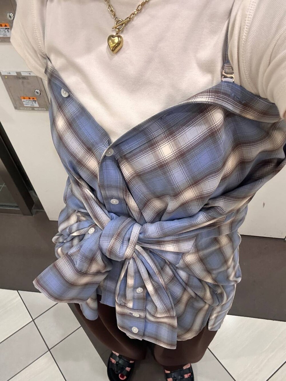 ブラウン系のスウェットパンツ、ブラック系のサンダル、ブラウン系のTシャツ/カットソーを着用したレディースの夏コーディネートの5枚目の写真