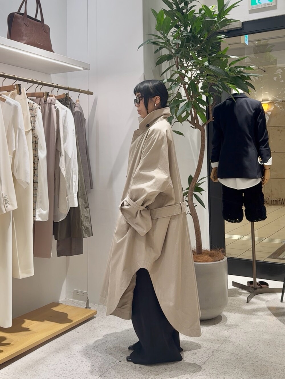 ベージュ系のポンチョ、グレー系のカーディガン/ボレロ、イエロー系のショルダーバッグを着用したレディースの冬コーディネートの3枚目の写真