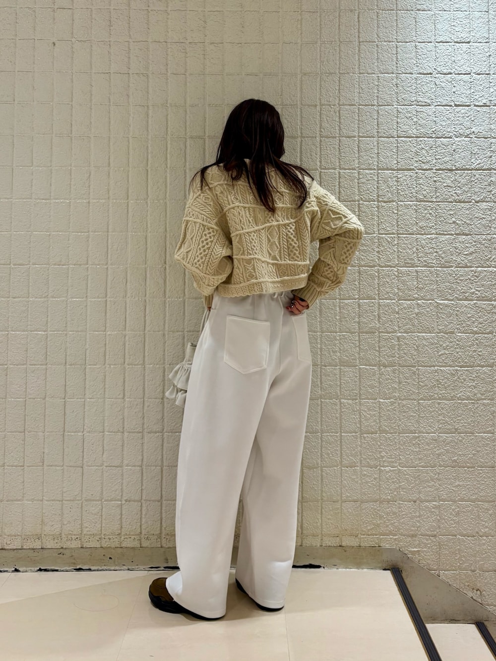 グリーン系のその他アウター、ベージュ系のニット/セーター、ホワイト系のその他パンツを着用したレディースの冬コーディネートの3枚目の写真