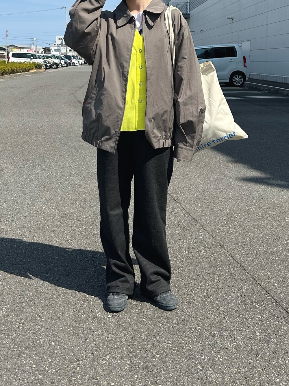 グリーン系のジャケット/アウター、ブルー系のトートバッグ、イエロー系のカーディガン/ボレロを着用したレディースの春コーディネートの2枚目の写真