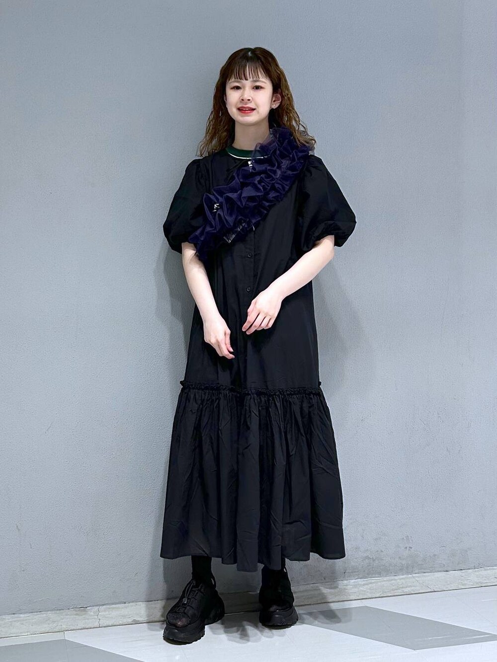 グリーン系のTシャツ/カットソー、ブラック系のシャツワンピース、パープル系のストール/ショールを着用したレディースの春コーディネートの4枚目の写真