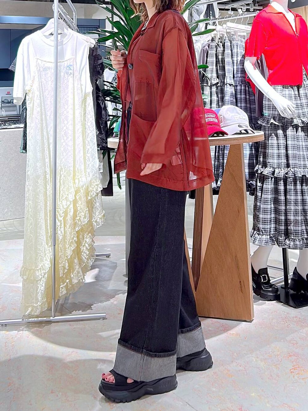 ブラック系のデニムパンツ、ブラック系のベスト、ブラック系のサンダルを着用したレディースの秋コーディネートの3枚目の写真